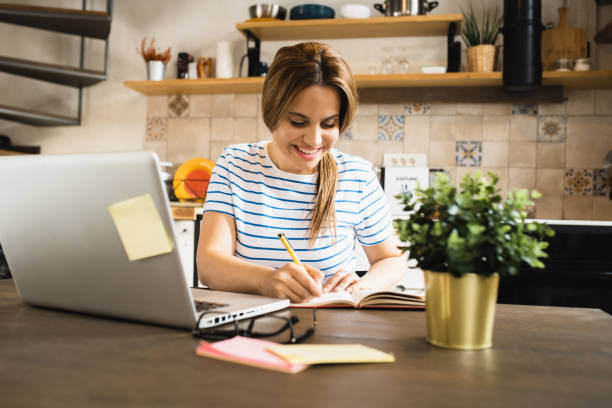 istock Happy young woman enjoying working online 1445859054