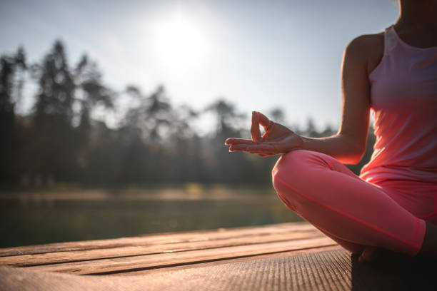 istock Woman In A Peaceful Meditating Posture In Nature 1445859370
