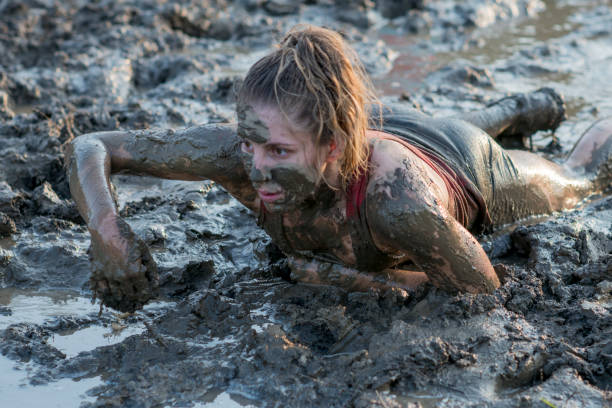 istock Woman Competing in a Mud Run 1445861125