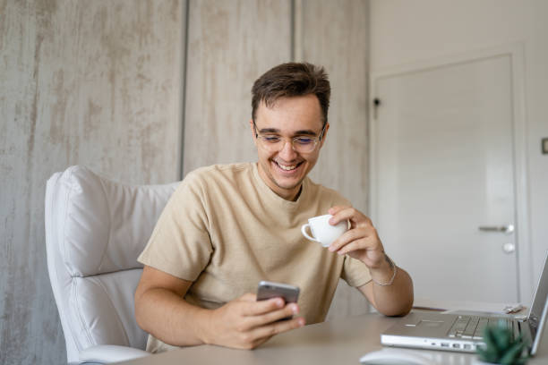 istock one caucasian man making a phone call at work in the office sitting 1445862638