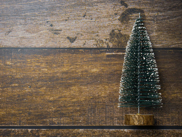 istock Christmas tree on wood table for holiday concept 1445871692