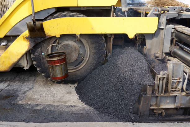 istock asphalt finisher placing a layer of asphalt 1445874785