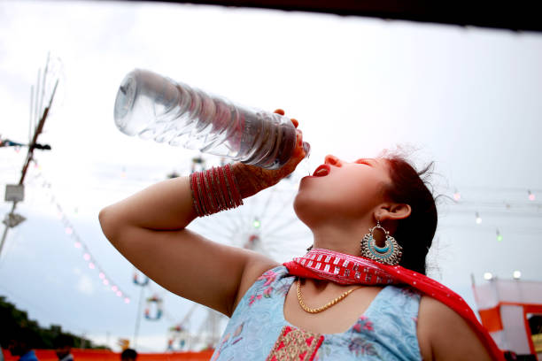 istock Women drinking water in Funfair during summer sunny day 1445875619