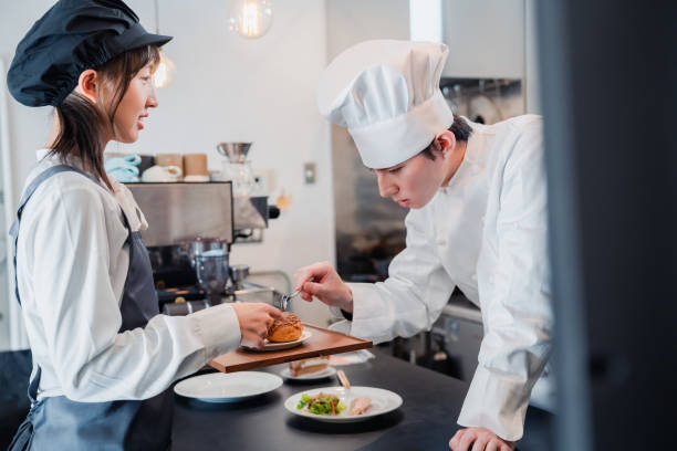 istock Male and female staff working happily at a restaurant 1445876280