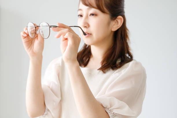 A woman checking the quality of eyeglass lenses and frames stock photo