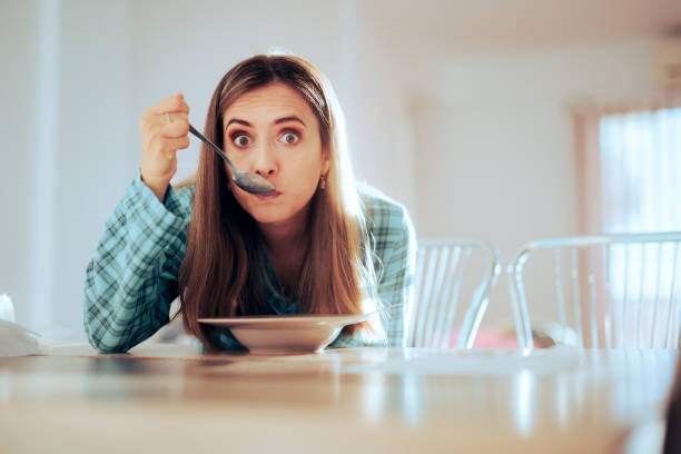 Girl having a snack all by herself in the living room
