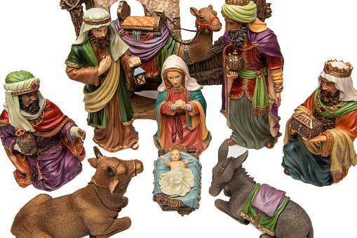 Christmas nativity scene with three Wise Men presenting gifts to baby Jesus