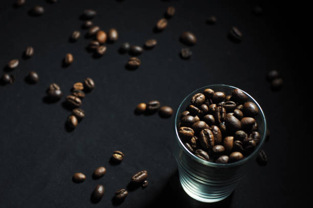 coffee beans in a glass on a black background
