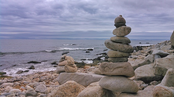 Balanced stones on a pebble beach during sunset. Croatia, Brela, Makarska. Summer and Vacation concept.
