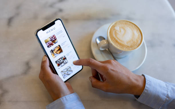 istock Close-up on a person at a cafe looking at a digital menu 1445890777