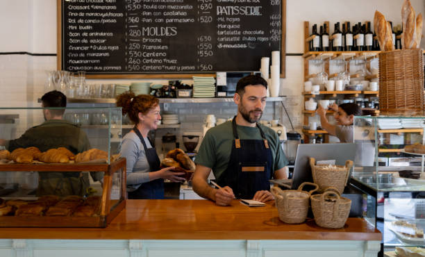 istock Business owner working at a cafe with his team 1445890823