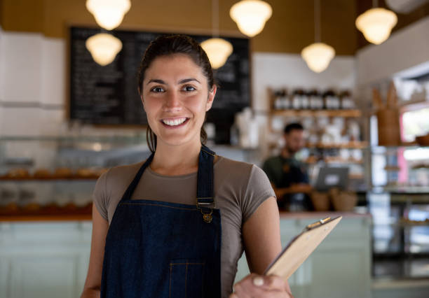 istock Happy woman working as a waitress at a cafe 1445891002