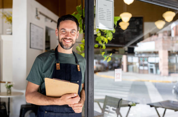 istock Happy waiter working at a cafe 1445891010