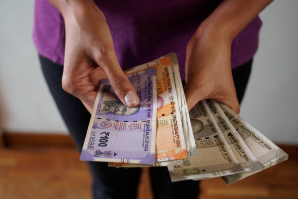 istock New Indian Rupee notes in the hands of a person 1445896447