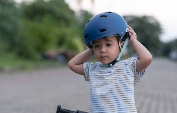 istock Little kid Boy adjusting bike helmet 1445901444