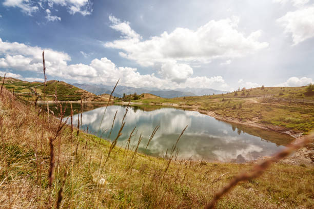 The large and small Pfaffensee in South Tyrol Italy are a well-known destination for hikers and mountain bikers. Beautiful reflections of the sky in the lake.