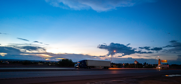 Semi-trucks driving on the highway at blue hour - motion blur
