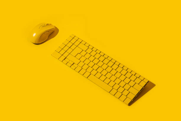 istock Yellow wireless keyboard and yellow computer mouse on a yellow background 1445907333
