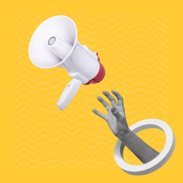 istock Hand catching a flying loudspeaker on a creative abstract yellow background 1445907693