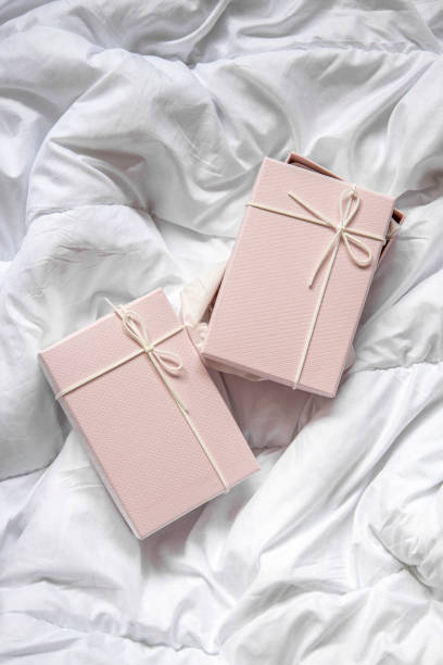 istock Two gift boxes on a crumpled white blanket. Top view, flat lay 1445908645