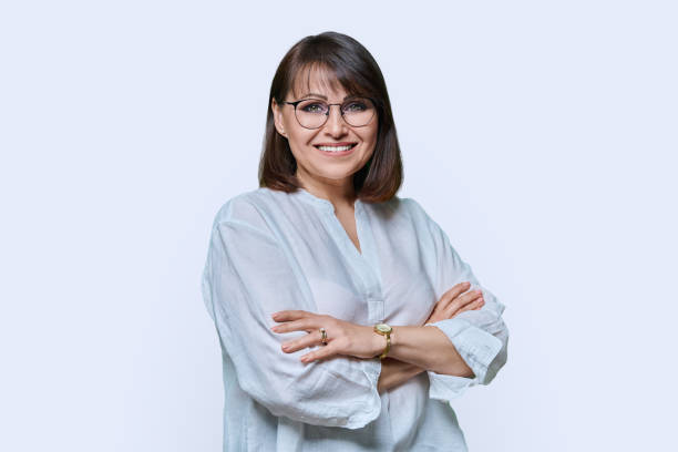 istock Positive middle aged woman looking at camera on white studio background 1445911776