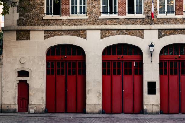 istock View of an old beautiful fire station building with red doors in Paris 1445916611