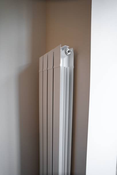 istock Vertical shot of a white heater device on a wall in a room 1445916931