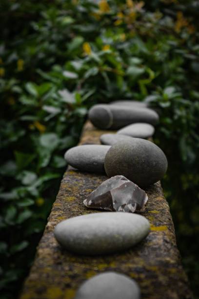 istock Vertical closeup shot of smooth and sharp gray rocks on a bridge 1445917253