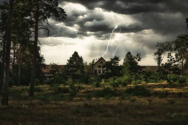 istock Stormy sky with gray clouds over an old house in a field 1445918092
