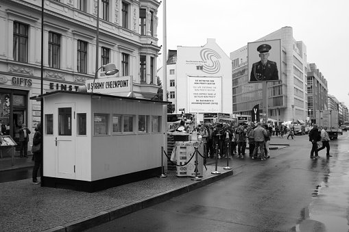 Berlin, Germany – September 20, 2013: A white and black shot of the Checkpoint Charlie in Berlin on a rainy day