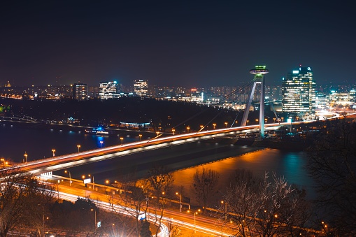 An aerial shot of the Most SNP Bridge in Bratislava, Slovakia illuminated at night
