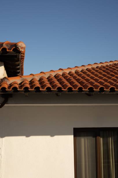 istock White house with a red roof under the sunlight 1445918488