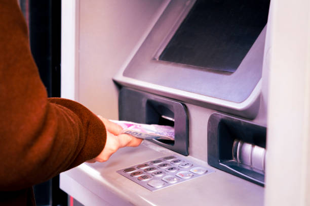 istock Someone who deposits money at the ATM 1445919247