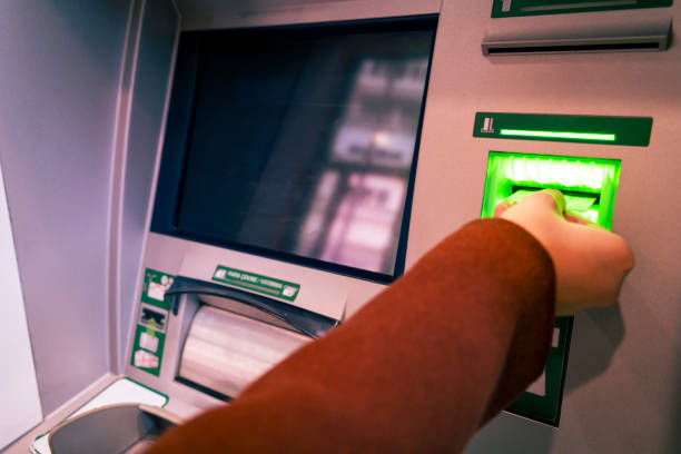 Someone who deposits money at the ATM stock photo