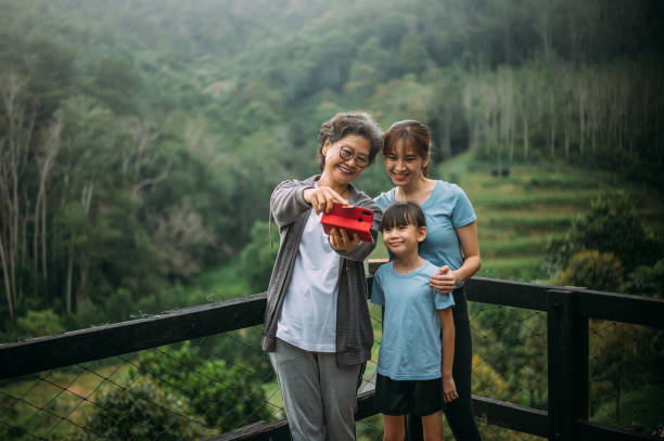 istock Smiling multi-generation Asian family taking selfie  at the backyard 1445919559