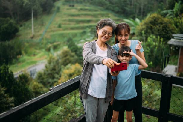 istock Happy multi-generation Asian family take selfie at back yard 1445919641