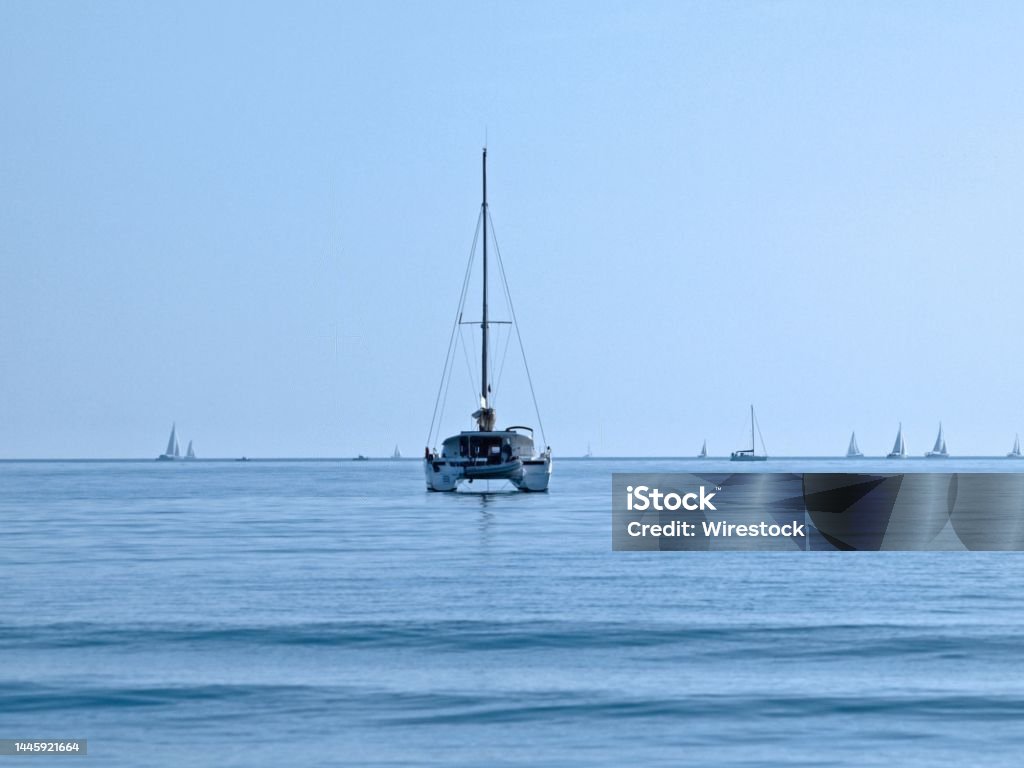 Sailboat floating on grand traverse bay A sailboat floating on grand traverse bay Bay of Water Stock Photo