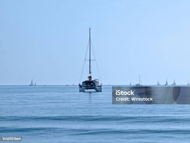Sailboat Floating On Grand Traverse Bay Stock Photo - Download Image Now - Bay of Water, Beach, Blue