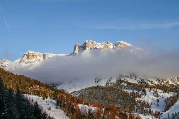 A scenery of clouds in front of Pela the Vit in the Dolomites, Valgardena, South Tirol, Italy