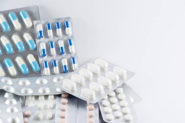 istock Bunch of different pills stacked on a white background 1445923705