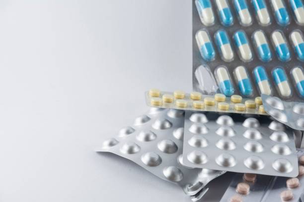 istock Bunch of different pills stacked on a white background 1445923707