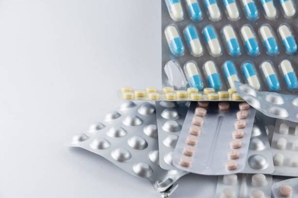 istock Bunch of different pills stacked on a white background 1445923717