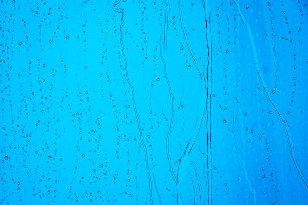 A closeup of water droplets on a glass surface