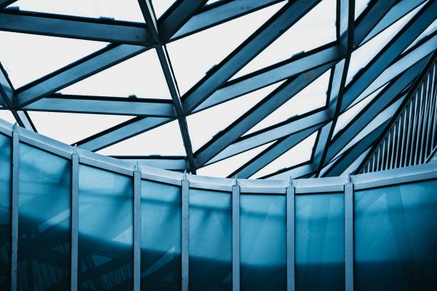 A low angle shot of a modern building interior with a glass design