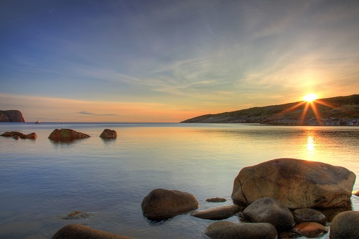 A beautiful shot of a sunrise sky over the rocky shore of Flatrock, Newfoundland and Labrador, Canada