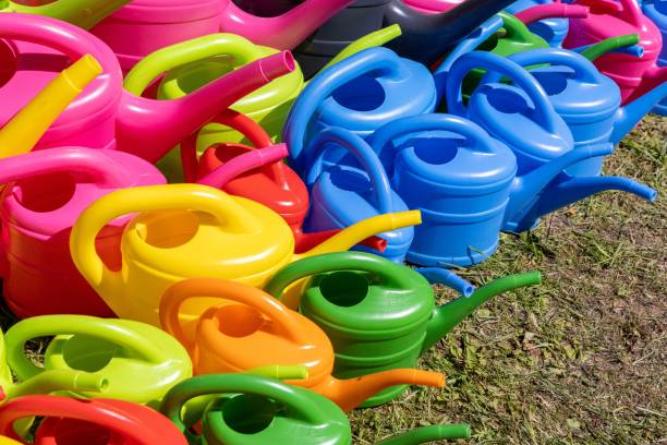 A high angle shot of colorful vibrant plastic watering cans