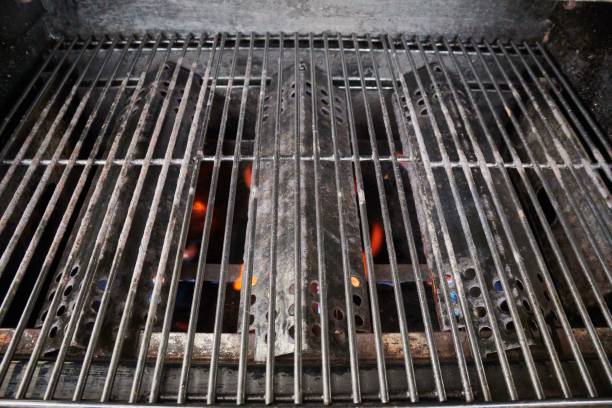 istock Closeup of cast-iron grill grate littech with fire under 1445926512