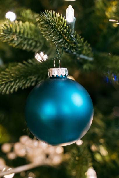 istock Blue Christmas ball ornament hanging on artificial Christmas tree 1445928914