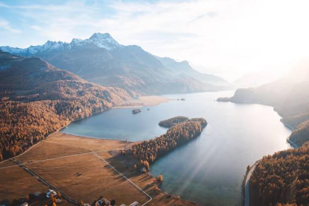 istock Lake surrounded by hills and mountains covered with vegetation under the sunlight 1445929996