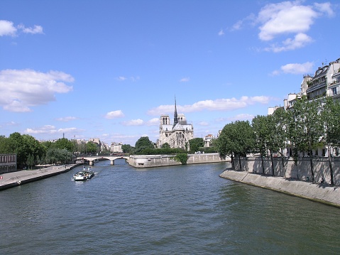 The Cathedral Notre-Dame of Paris on the other side of the Seine River in Paris, France